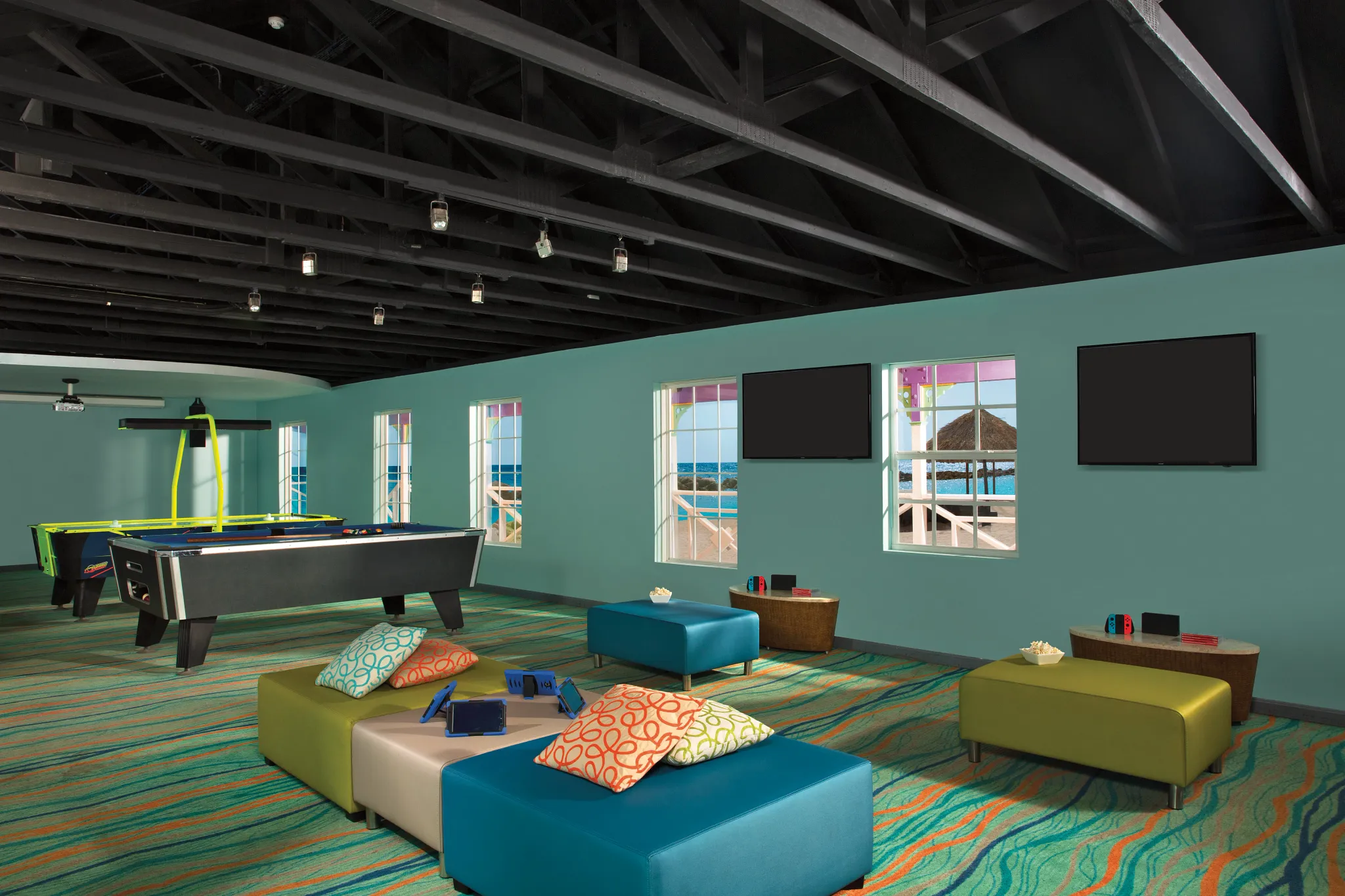 Teen game lounge with pool table and gaming stations at Sunscape Curaçao Resort, Spa & Casino.