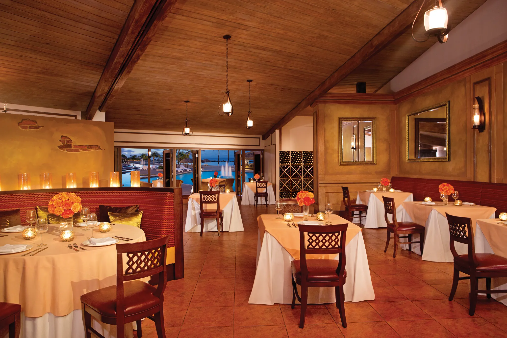 Da Mario Italian restaurant at Sunscape Curaçao Resort featuring elegant candlelit dining, warm wood interiors, and views toward the resort pool.