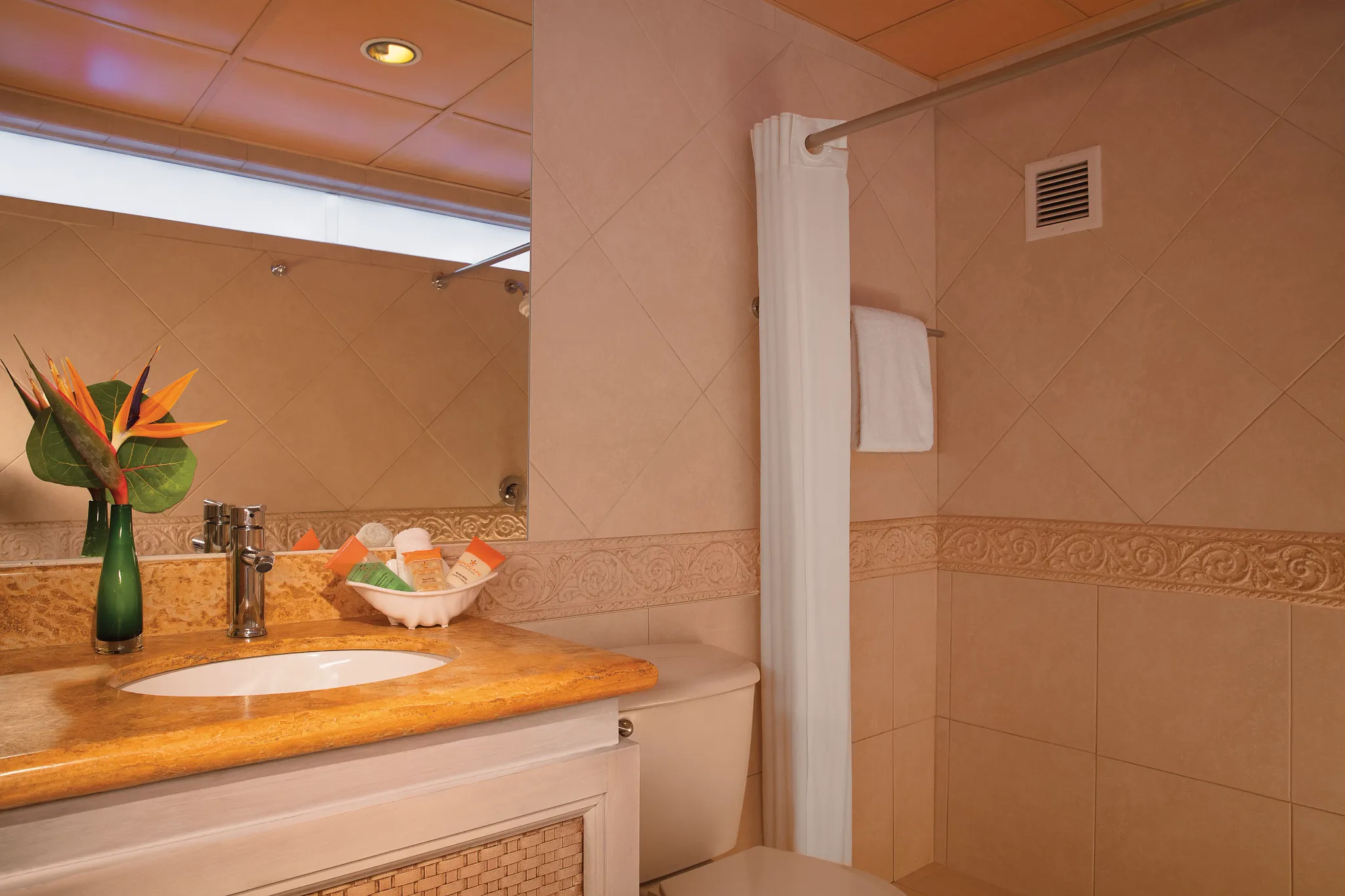 Deluxe Garden View bathroom with vanity and shower at Sunscape Curaçao Resort.