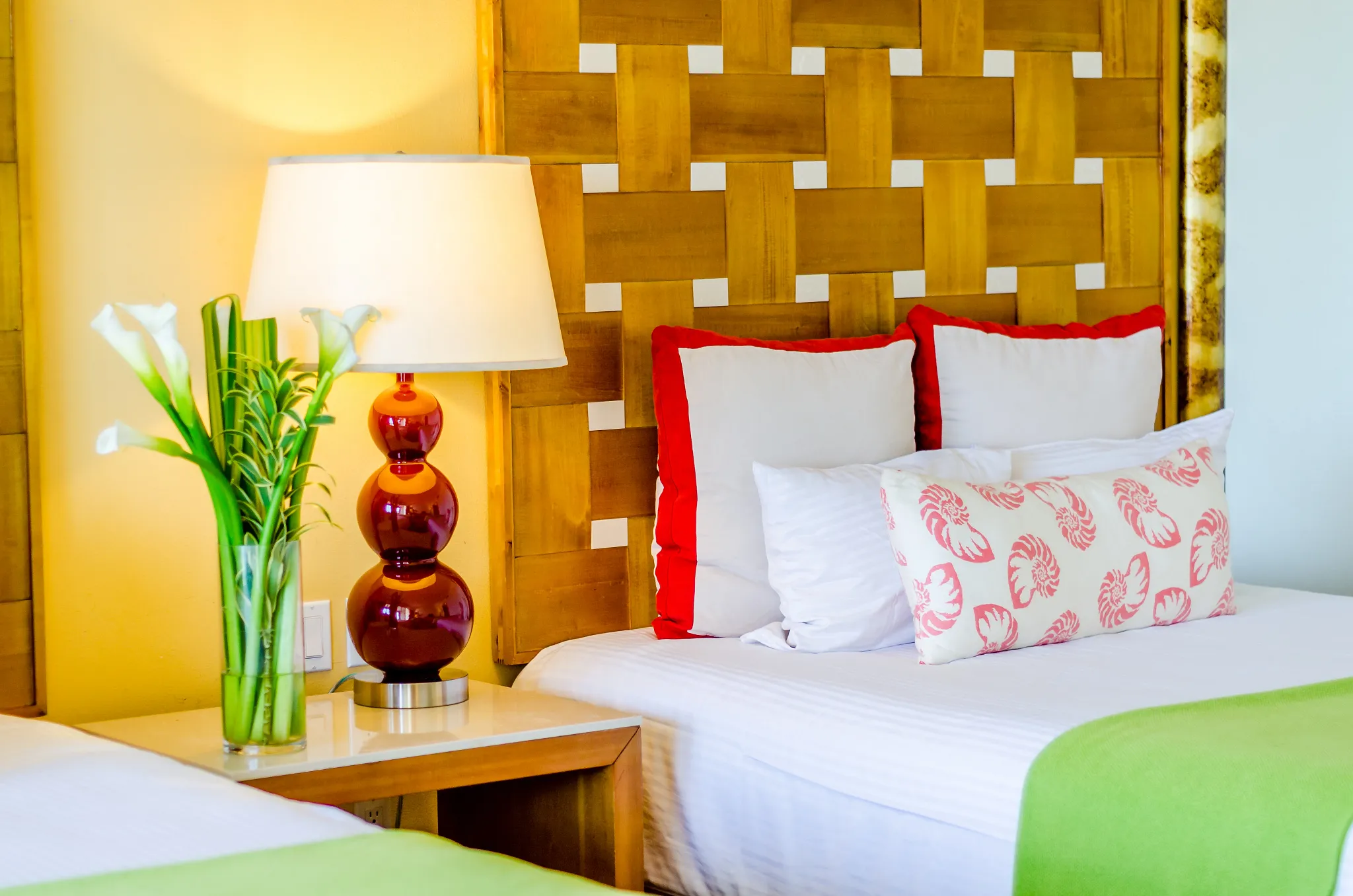Deluxe Garden View room detail with double beds and tropical décor at Sunscape Curaçao Resort.