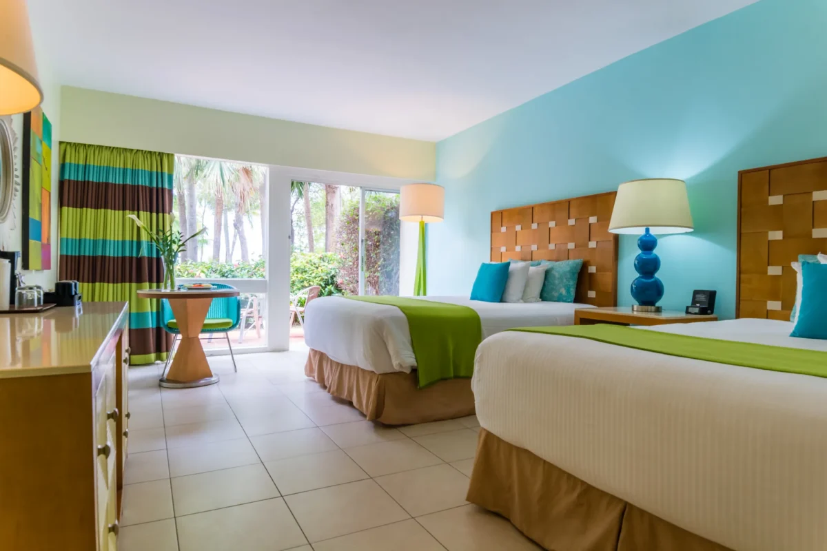 Double Deluxe room with two double beds and garden terrace at Sunscape Curaçao Resort, Spa & Casino.