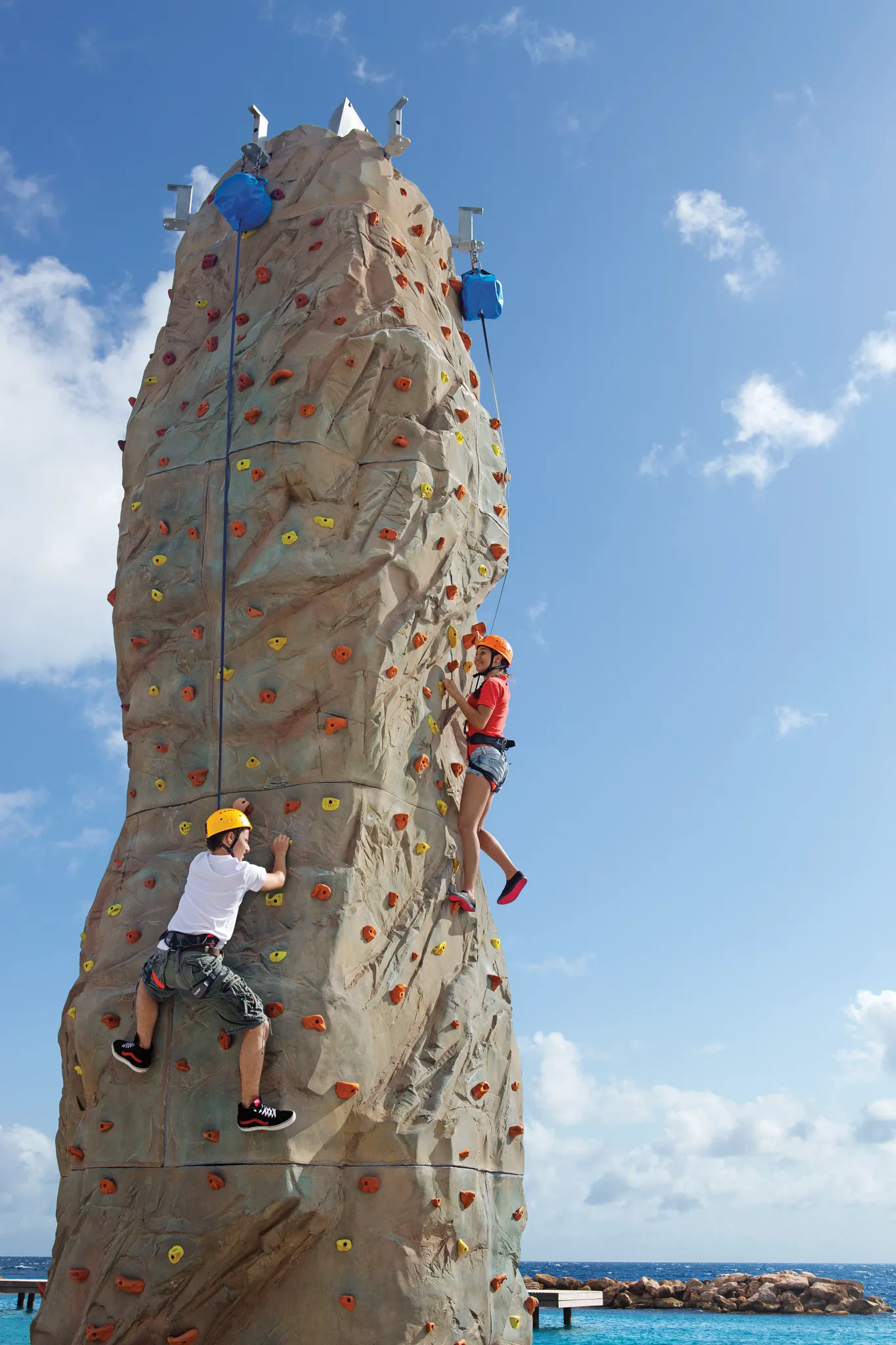 Guests climbing an outdoor rock wall activity at Sunscape Curaçao Resort, Spa & Casino.