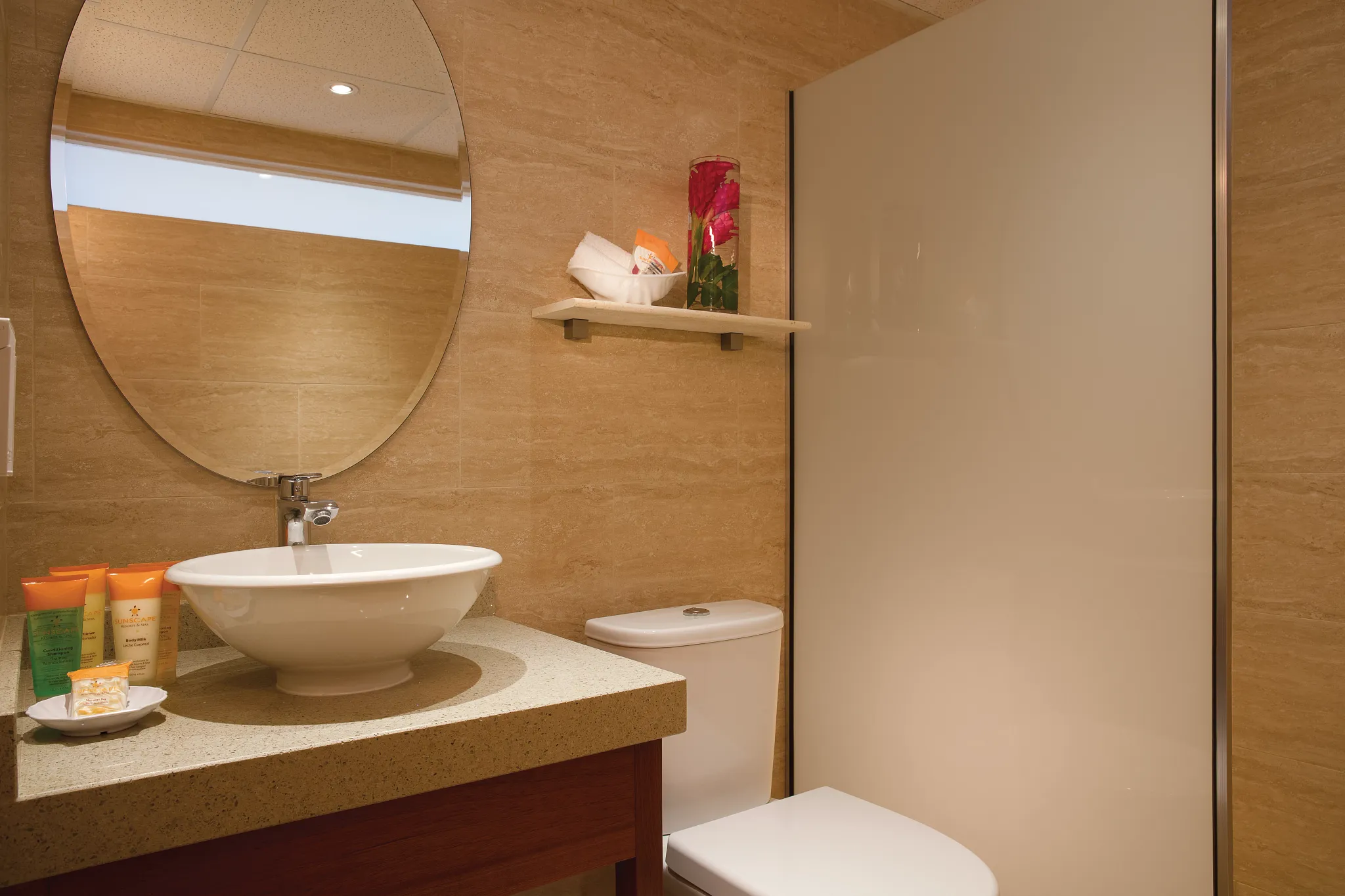 Sun Club Deluxe Ocean View bathroom with vanity sink and shower at Sunscape Curaçao Resort.