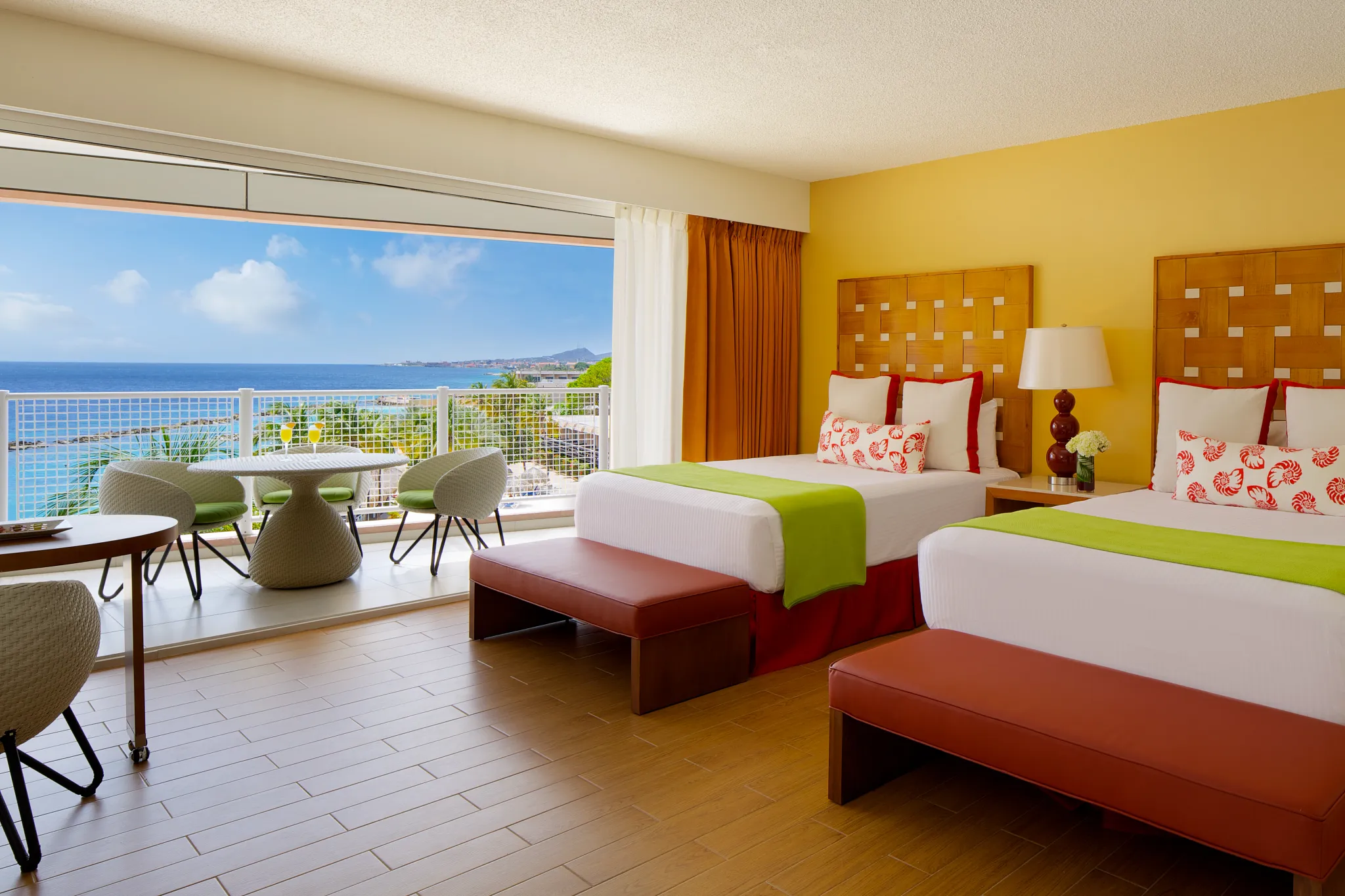 Sun Club Deluxe Ocean View room with two double beds and oceanfront balcony at Sunscape Curaçao Resort, Spa & Casino.