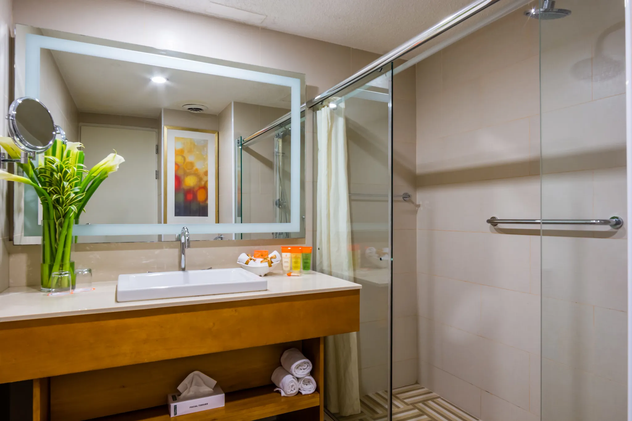 Sun Club Junior Suite Ocean View bathroom with vanity sink and glass shower at Sunscape Curaçao Resort.