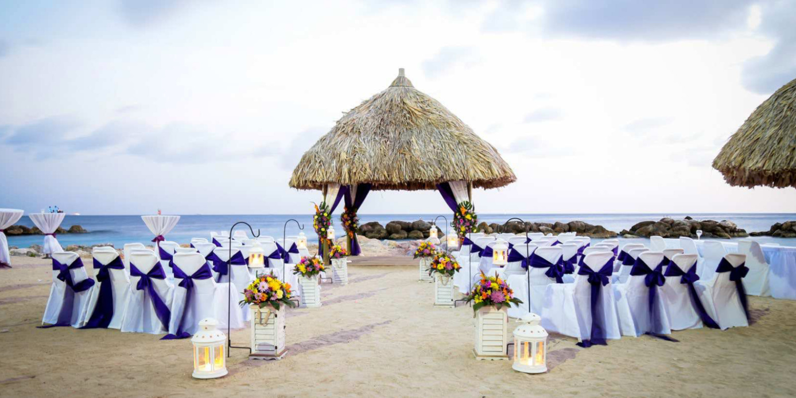 Beach wedding ceremony setup with thatched gazebo and ocean view at Sunscape Curaçao Resort, Spa & Casino