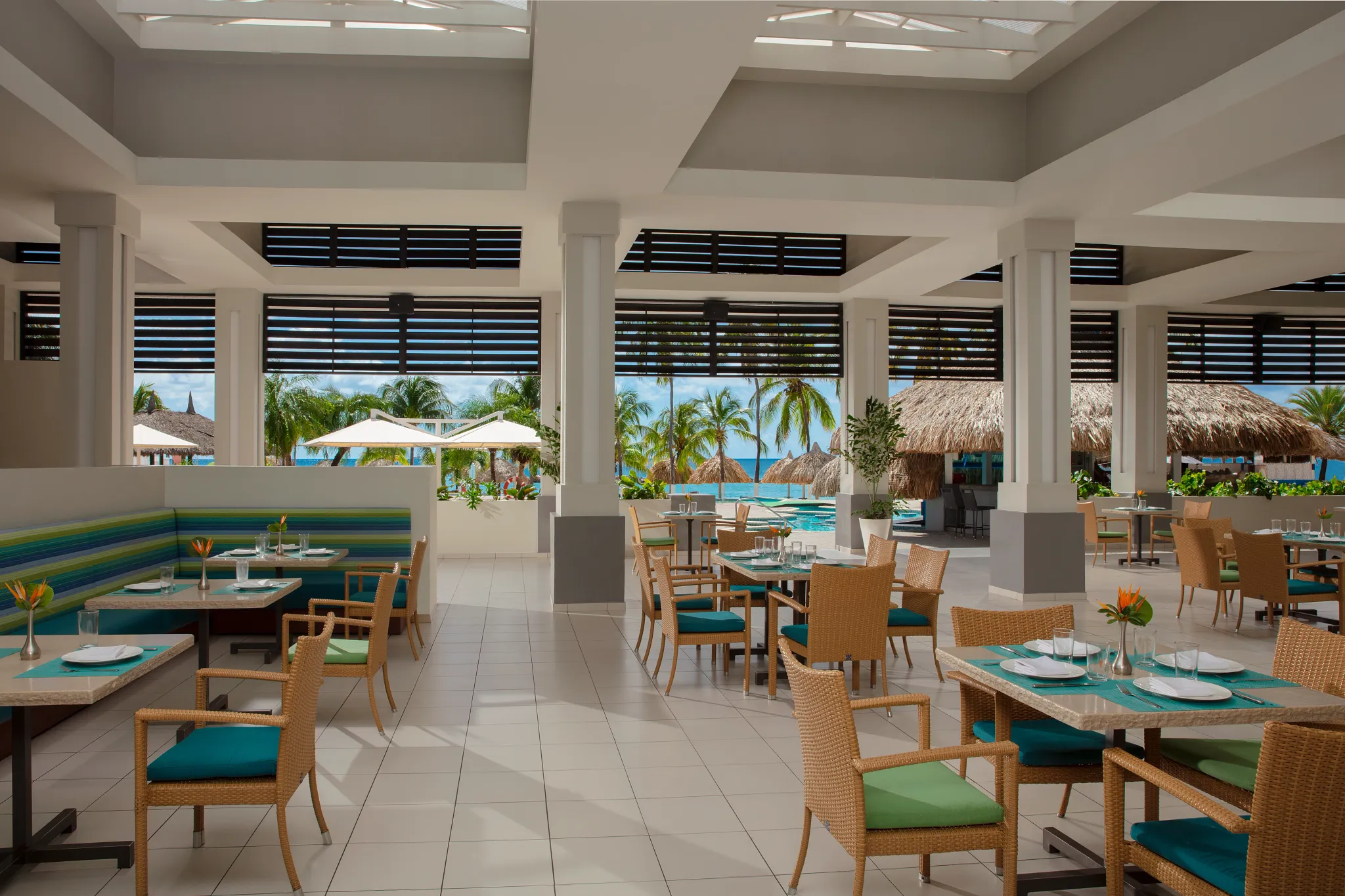 World Café open-air buffet restaurant at Sunscape Curaçao Resort featuring bright tropical dining space with pool and ocean views.